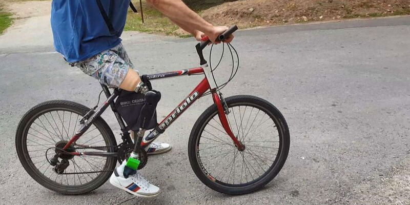 Amputee Riding a Bike Outside