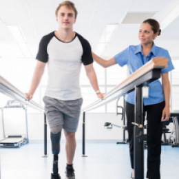 Photo of a man with a prosthetic device walking.