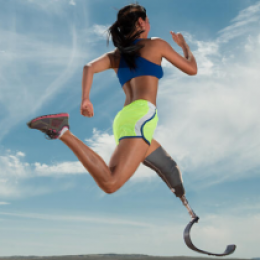 Woman with prosthetic leg running.